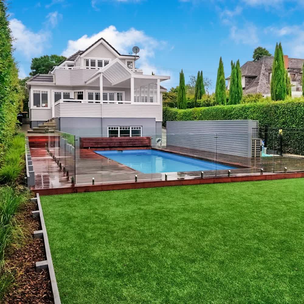 Backyard pool with deck and steps to upper level deck area